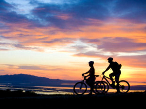 View of 2 bikers at sunset